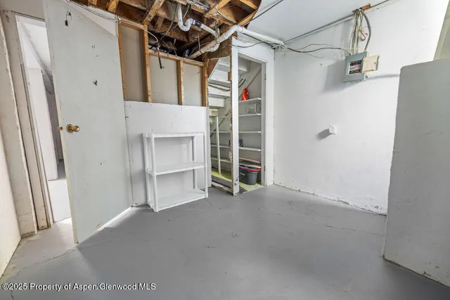 a view of a lake with beach and mountain in the back