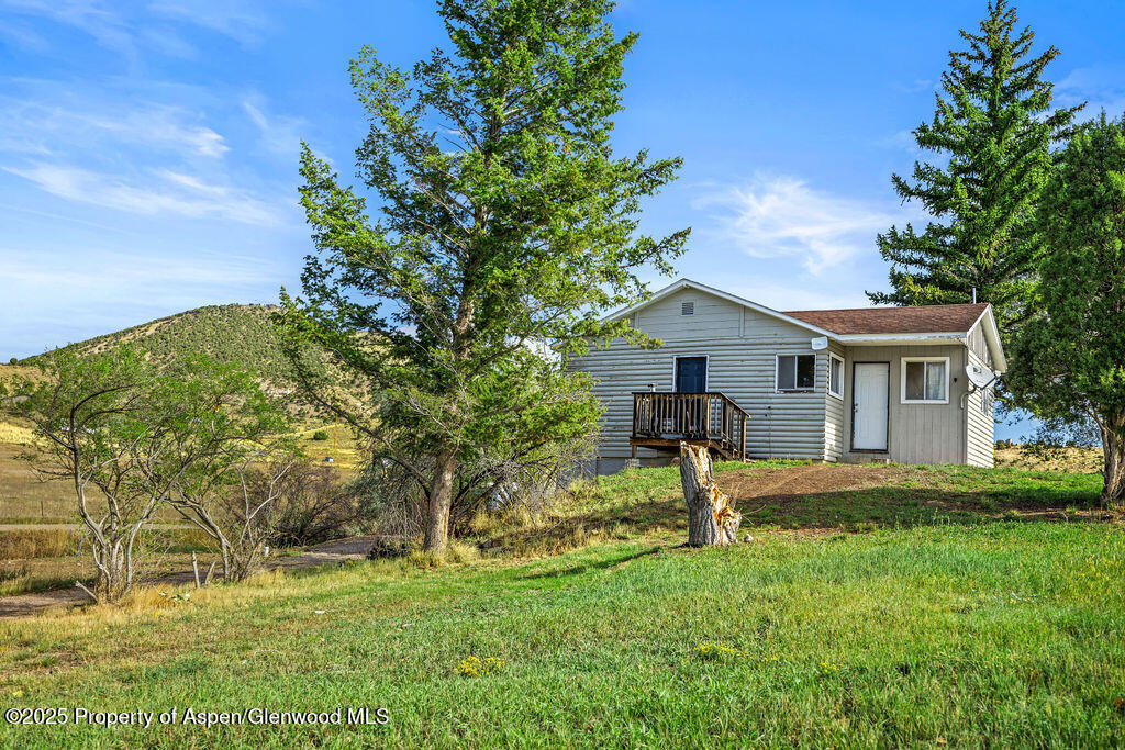 3362 County Road 7 Craig, CO 81625 - Photo 5 of 36 a front view of a house with a yard and trees