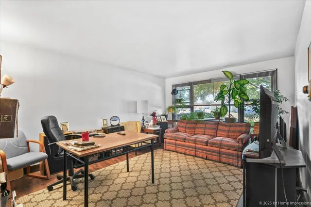 a living room with furniture a large window and a flat screen tv