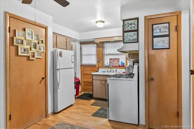 a kitchen with a refrigerator and a stove