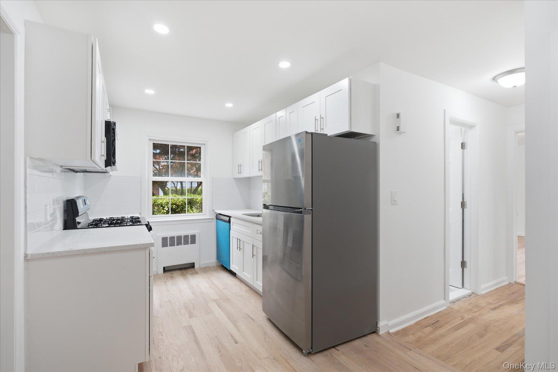 117 Robins Road, Unit 117 New Rochelle, NY 10801 - Photo 7 of 28 a kitchen with a refrigerator a stove top oven a sink and dishwasher