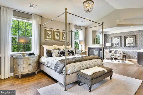 a room with a table chairs and mirrors