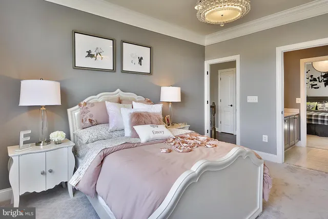 a hallway with a couch and chandelier