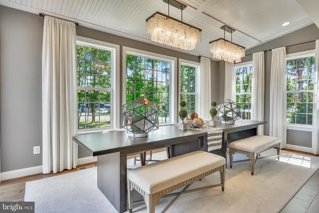 a dining room with a wooden table and chairs