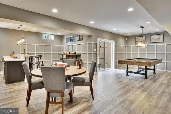 a living room with stainless steel appliances kitchen island granite countertop furniture and a wooden floor