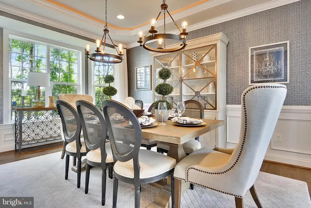 a view of a dining room with furniture wooden floor and chandelier