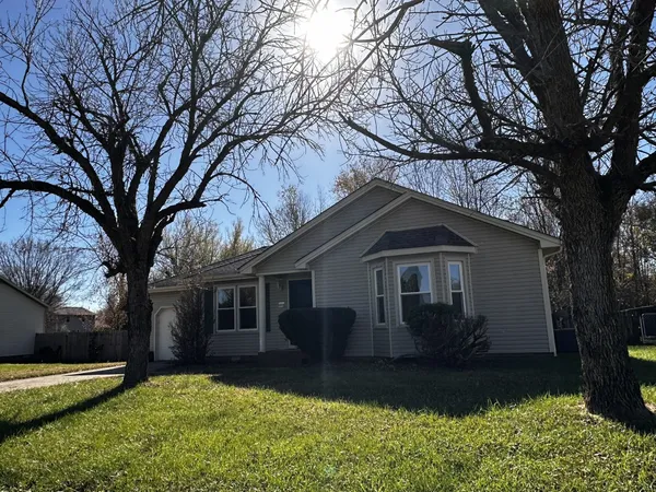 a house that has a tree in front of it