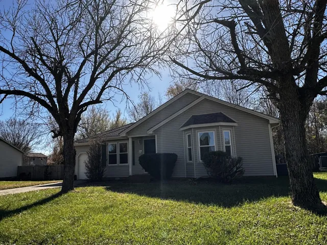 a house that has a tree in front of it