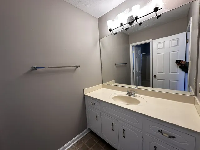 a bathroom with a sink double vanity granite and a mirror