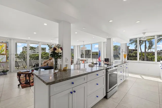 a kitchen with center island and windows
