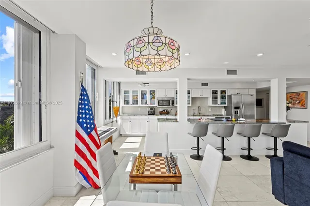 a living room with lots of furniture and a chandelier