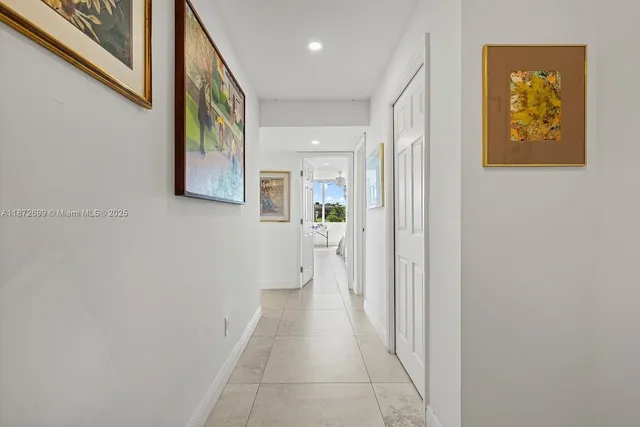 a hallway with wooden floor and a bathroom