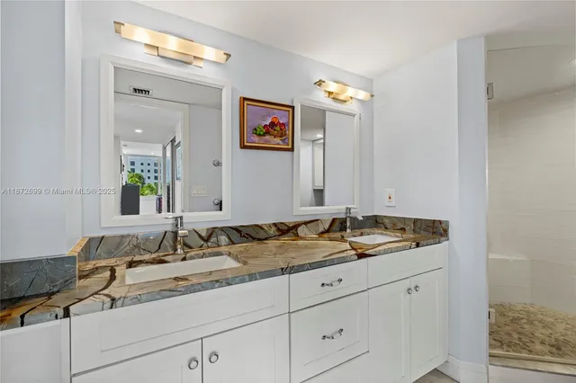 a bathroom with a granite countertop sink and a mirror