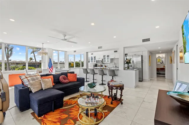 a living room with furniture kitchen and a table