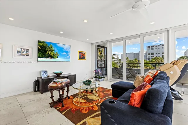 a living room with furniture a rug and a large window