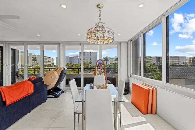 a view of a dining room with furniture large windows and wooden floor