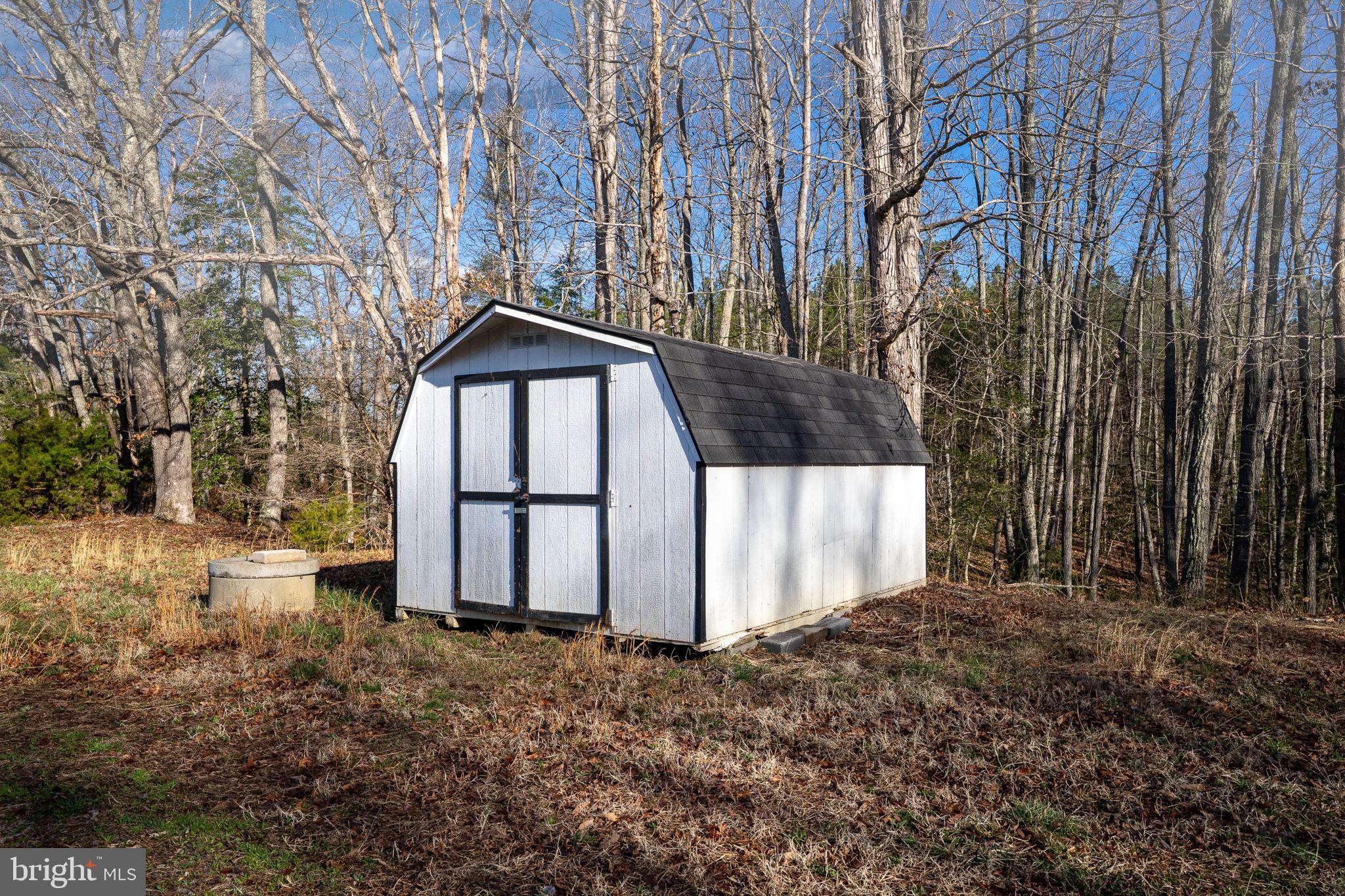 14227 Springfield Lane King George, VA 22485 - Photo 21 of 22 Charming shed nestled in nature's embrace.