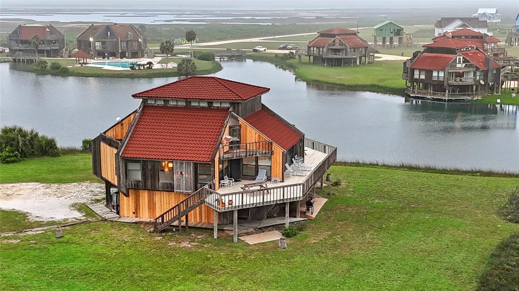 an aerial view of a house with pool lake view and boat