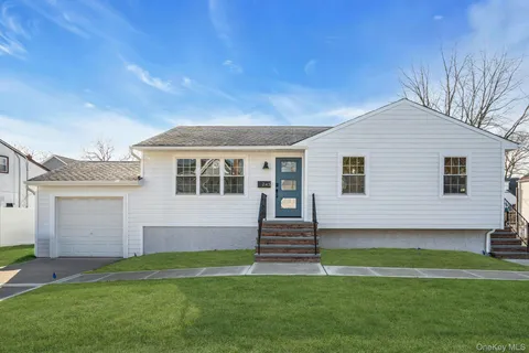 a front view of a house with a garden