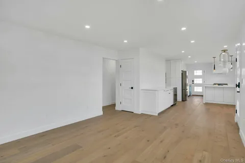 a view of a big room with wooden floor and windows