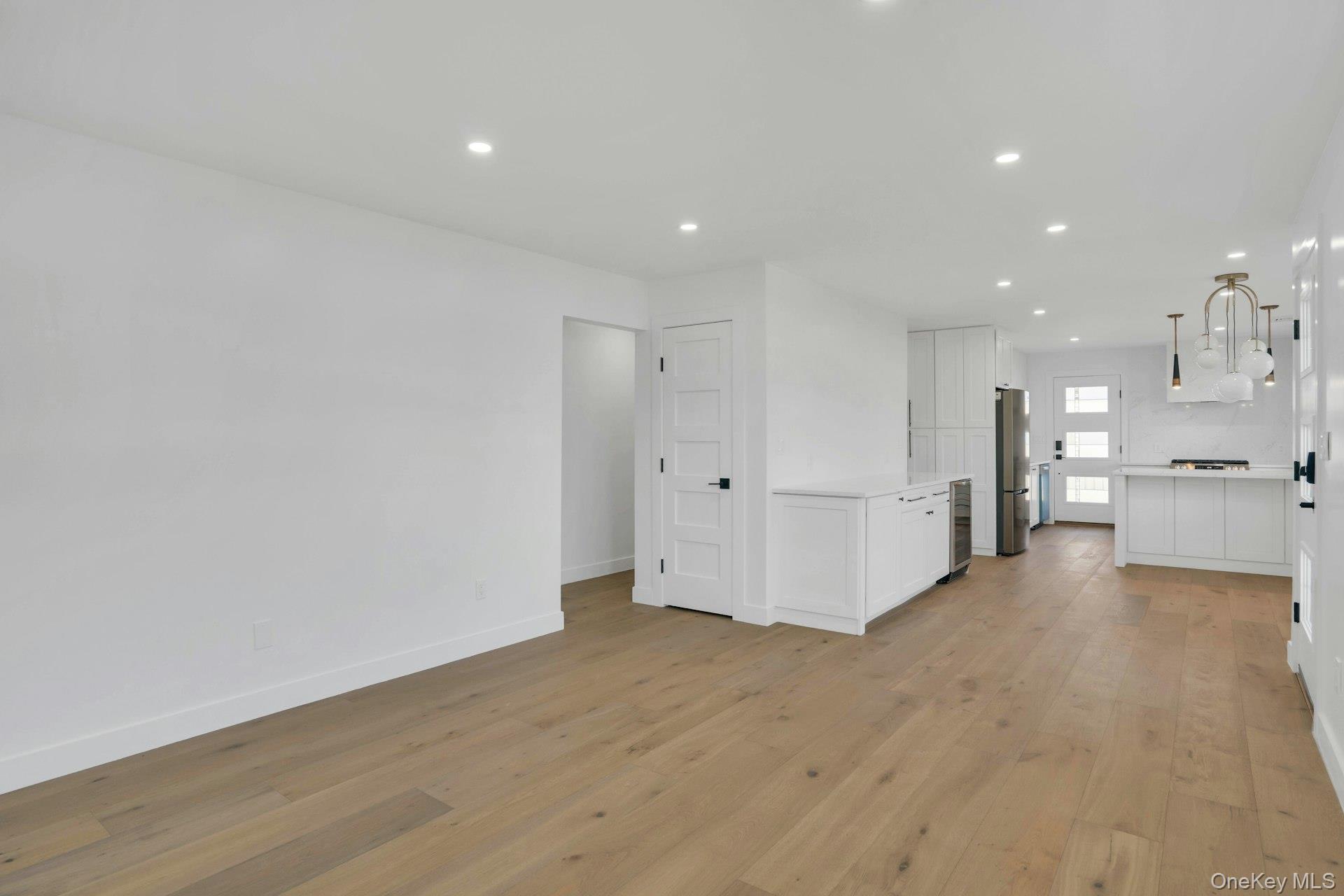 243 Lido Parkway Lindenhurst, NY 11757 - Photo 17 of 46 a view of a big room with wooden floor and windows