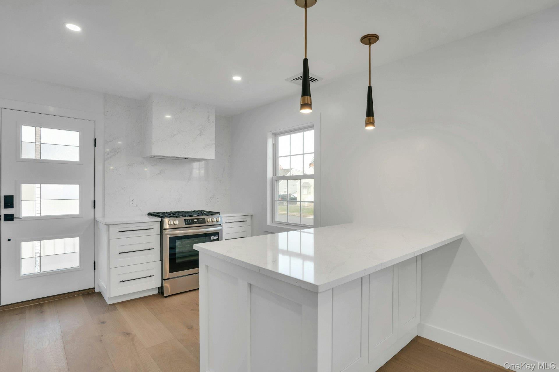 243 Lido Parkway Lindenhurst, NY 11757 - Photo 20 of 46 a kitchen with stove cabinets and wooden floor