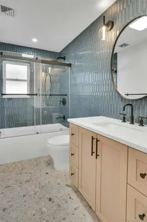 a bathroom with a sink a toilet and bathtub