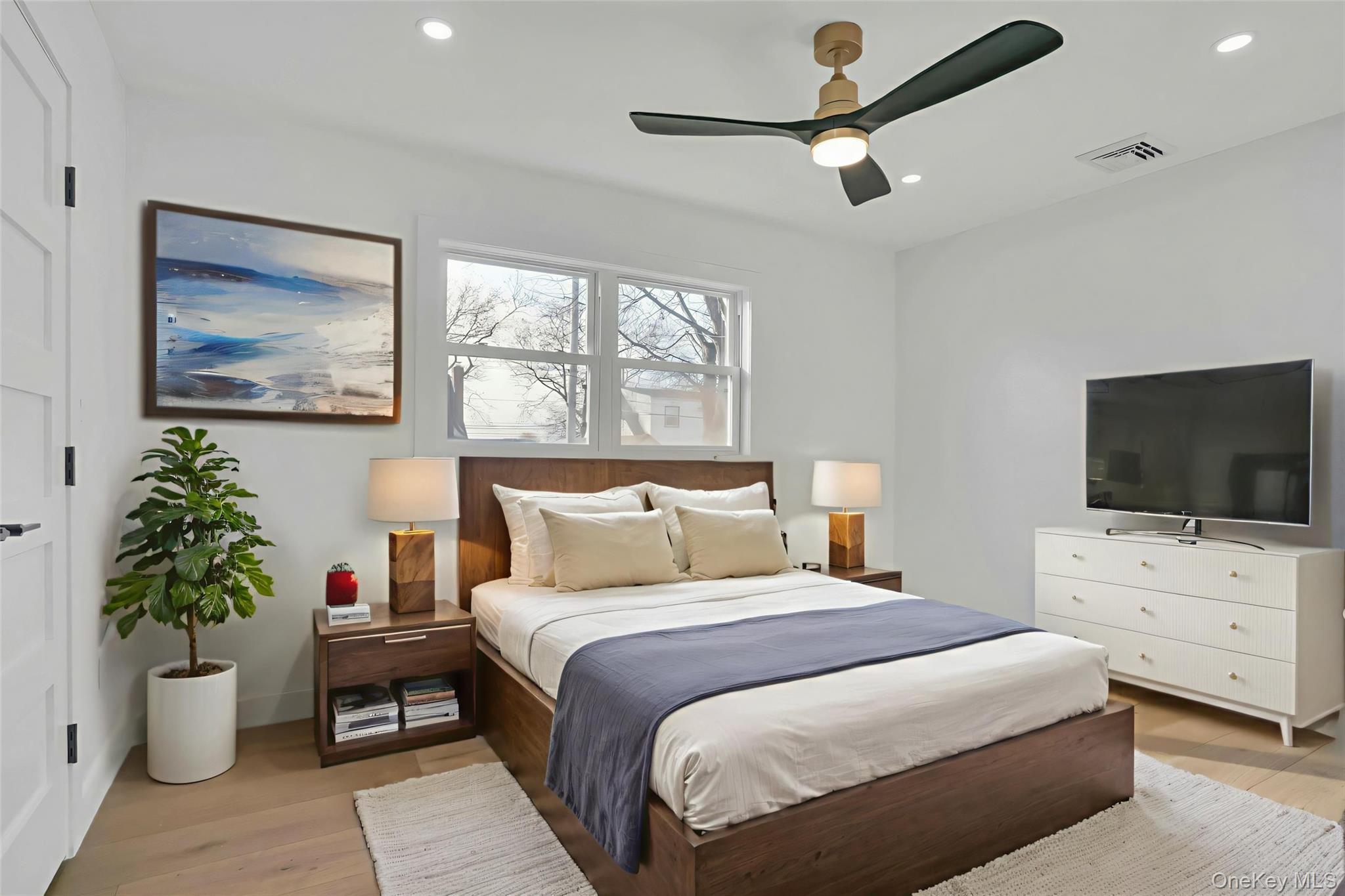 243 Lido Parkway Lindenhurst, NY 11757 - Photo 29 of 46 a bedroom with a bed and a flat screen tv