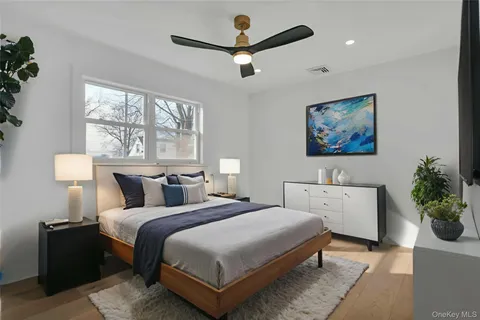 a bedroom with a large bed and a chandelier