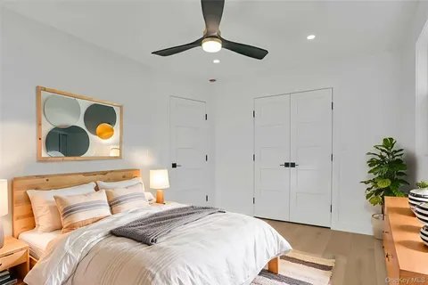 a bedroom with a bed and a painting on the wall