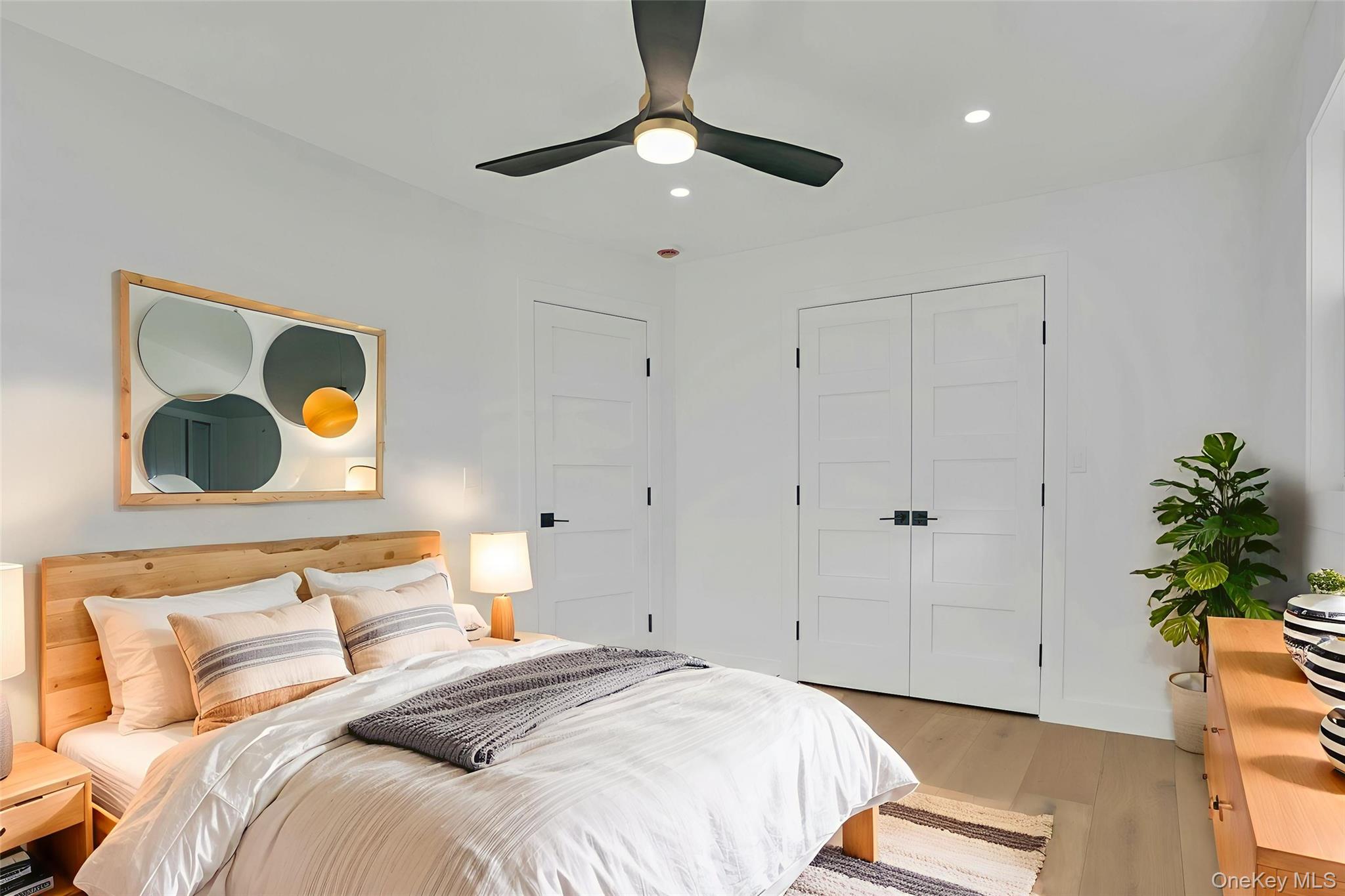 243 Lido Parkway Lindenhurst, NY 11757 - Photo 33 of 46 a bedroom with a bed and a painting on the wall