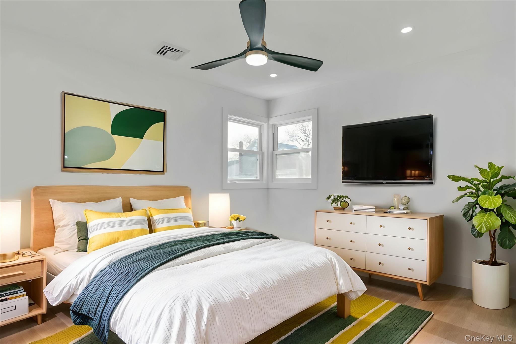 243 Lido Parkway Lindenhurst, NY 11757 - Photo 36 of 46 a bedroom with a bed and a flat screen tv