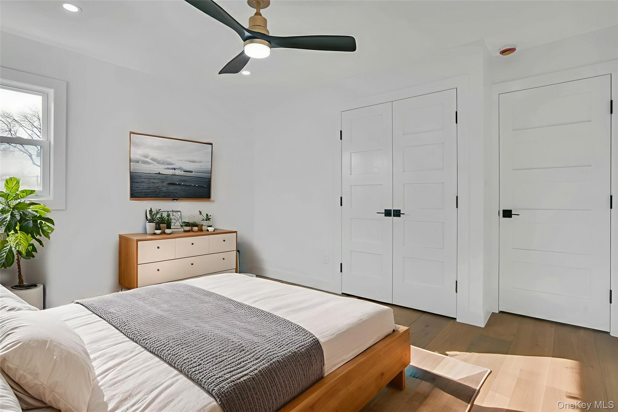 243 Lido Parkway Lindenhurst, NY 11757 - Photo 38 of 46 a bedroom with a bed and a dresser