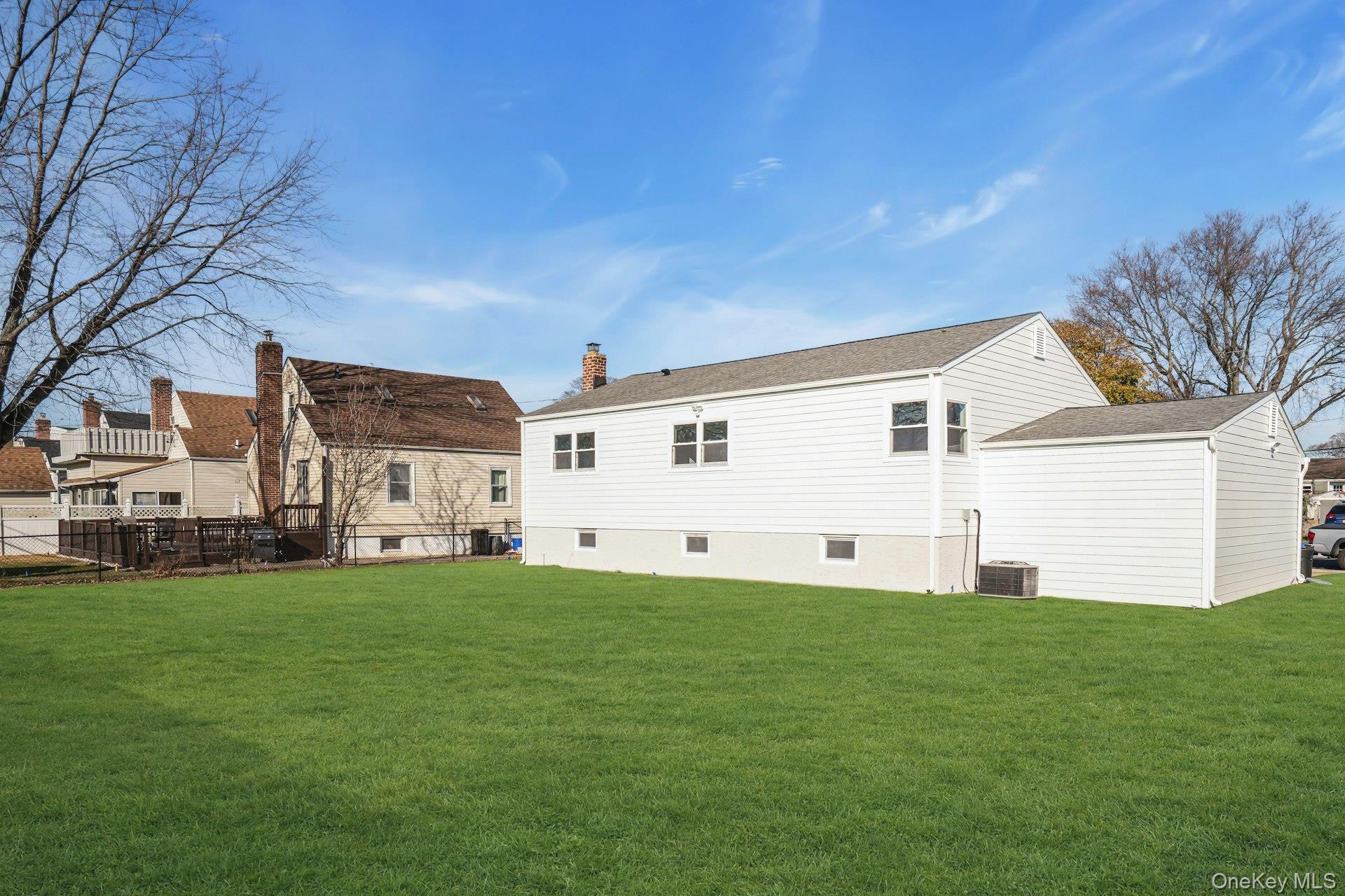 243 Lido Parkway Lindenhurst, NY 11757 - Photo 40 of 46 a big white house with a big yard and large trees