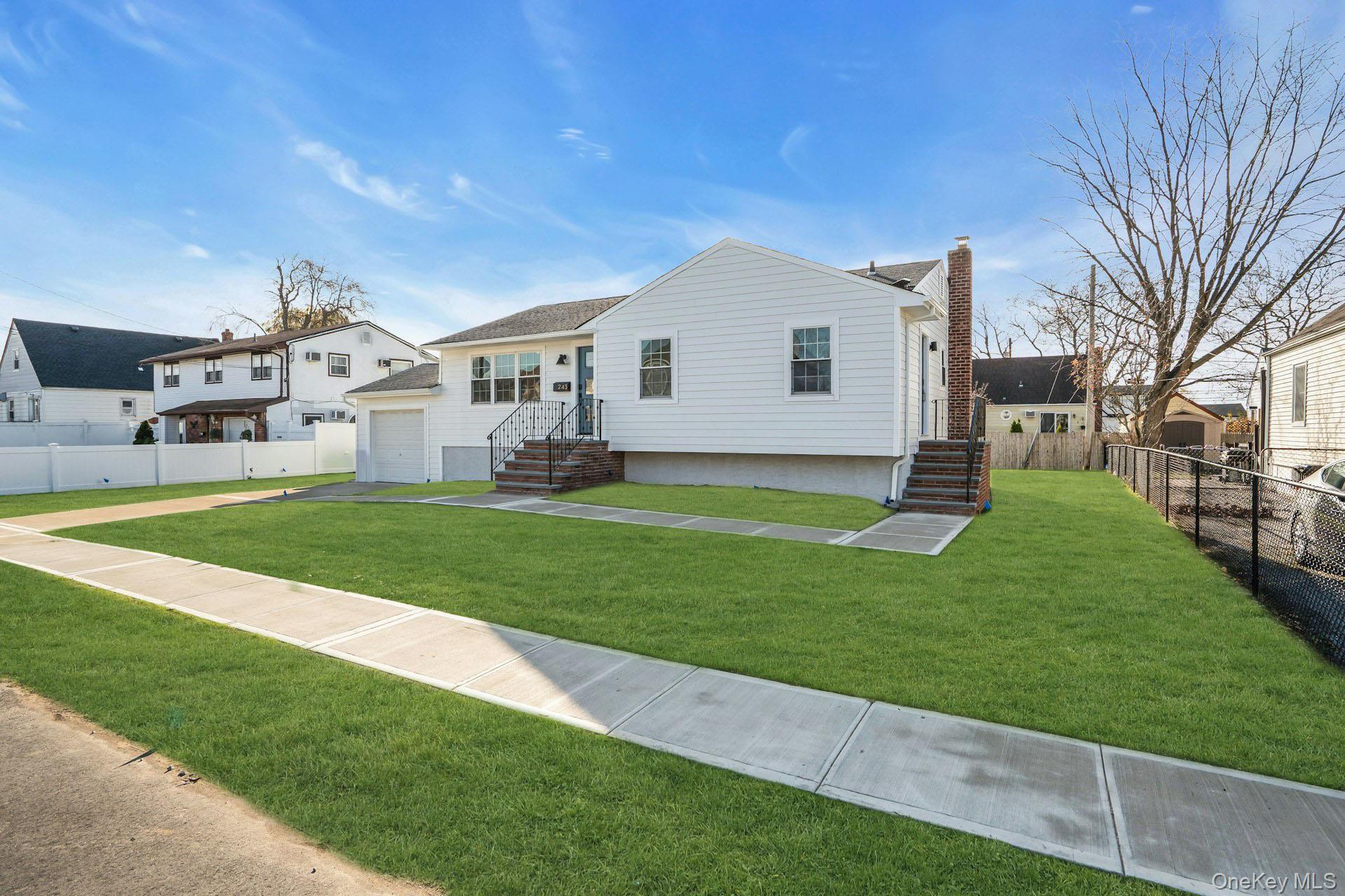 243 Lido Parkway Lindenhurst, NY 11757 - Photo 5 of 46 a front view of a house with a yard and trees