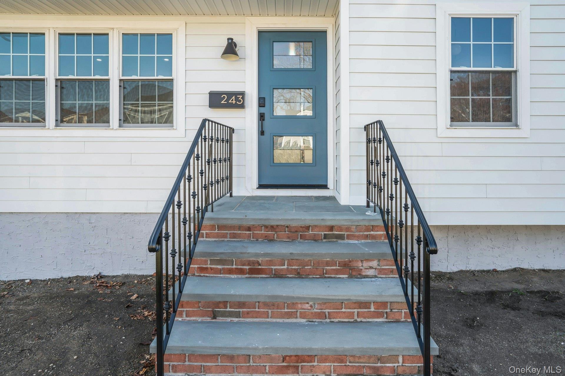 243 Lido Parkway Lindenhurst, NY 11757 - Photo 6 of 46 a view of staircase with white walls and windows