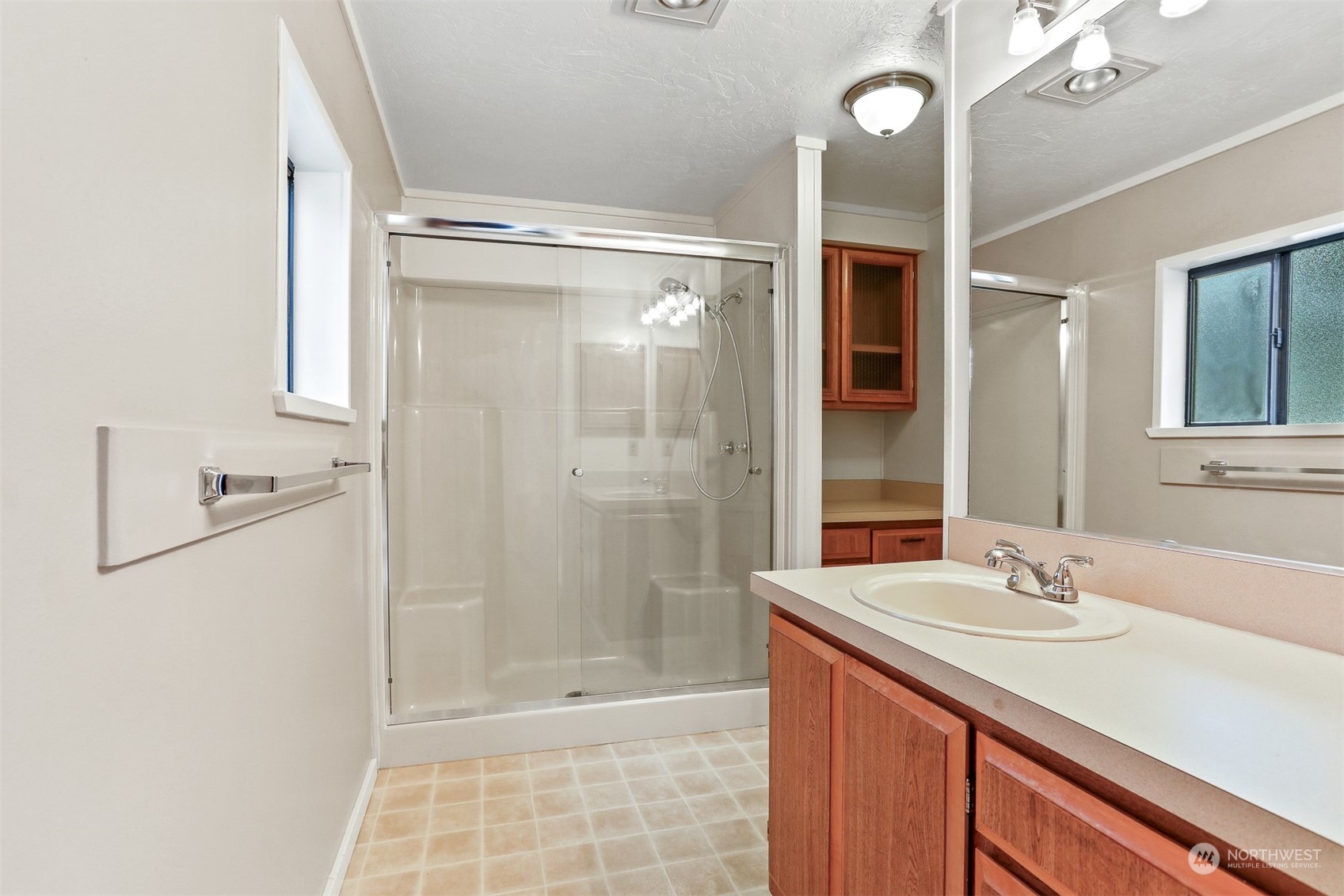 828 240th Place Southwest Bothell, WA 98021 - Photo 16 of 40 a bathroom with a sink a toilet a mirror and shower