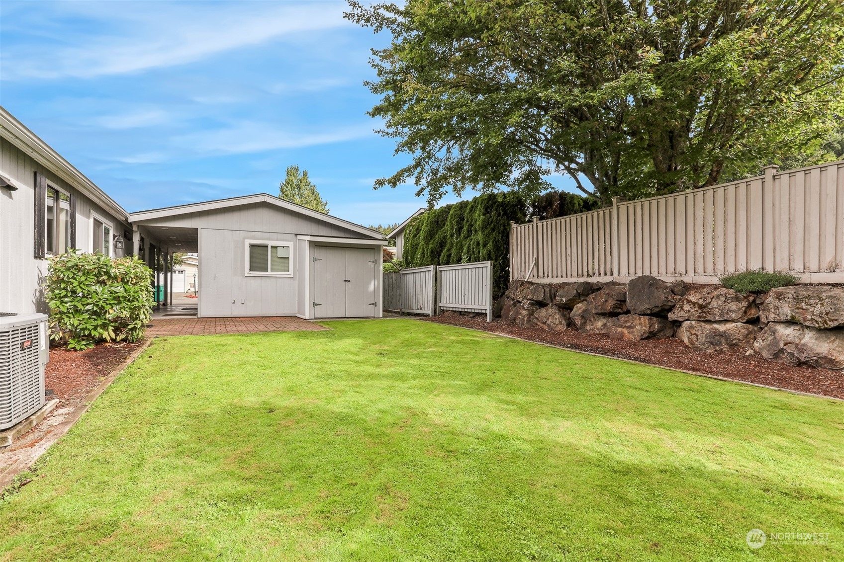 828 240th Place Southwest Bothell, WA 98021 - Photo 25 of 40 a view of a house with backyard and garden