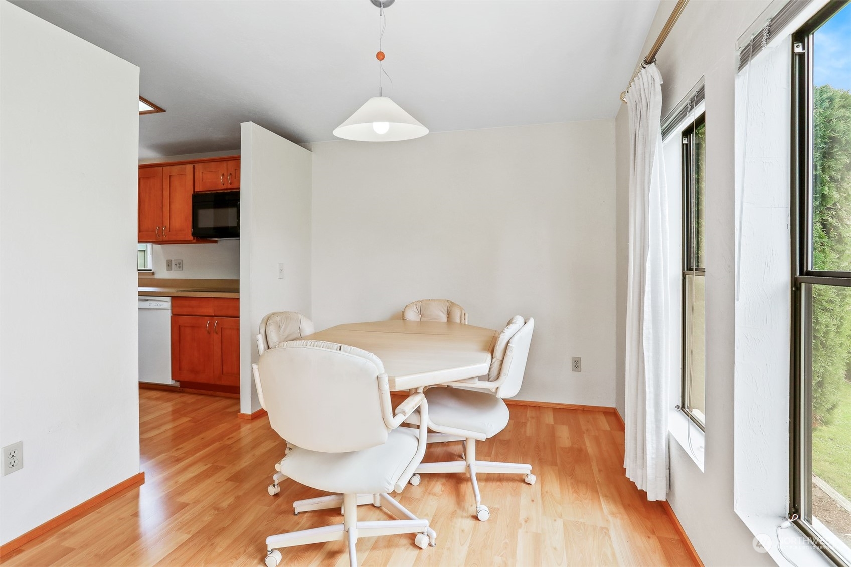 828 240th Place Southwest Bothell, WA 98021 - Photo 5 of 40 a view of a dining room with furniture and wooden floor