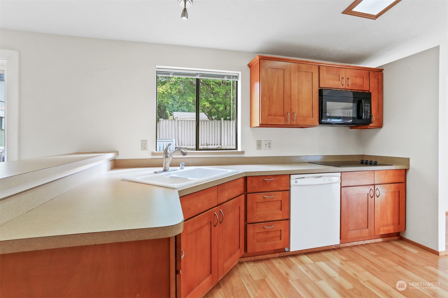 828 240th Place Southwest Bothell, WA 98021 - Photo 7 of 40 a kitchen with stainless steel appliances granite countertop a sink stove and microwave