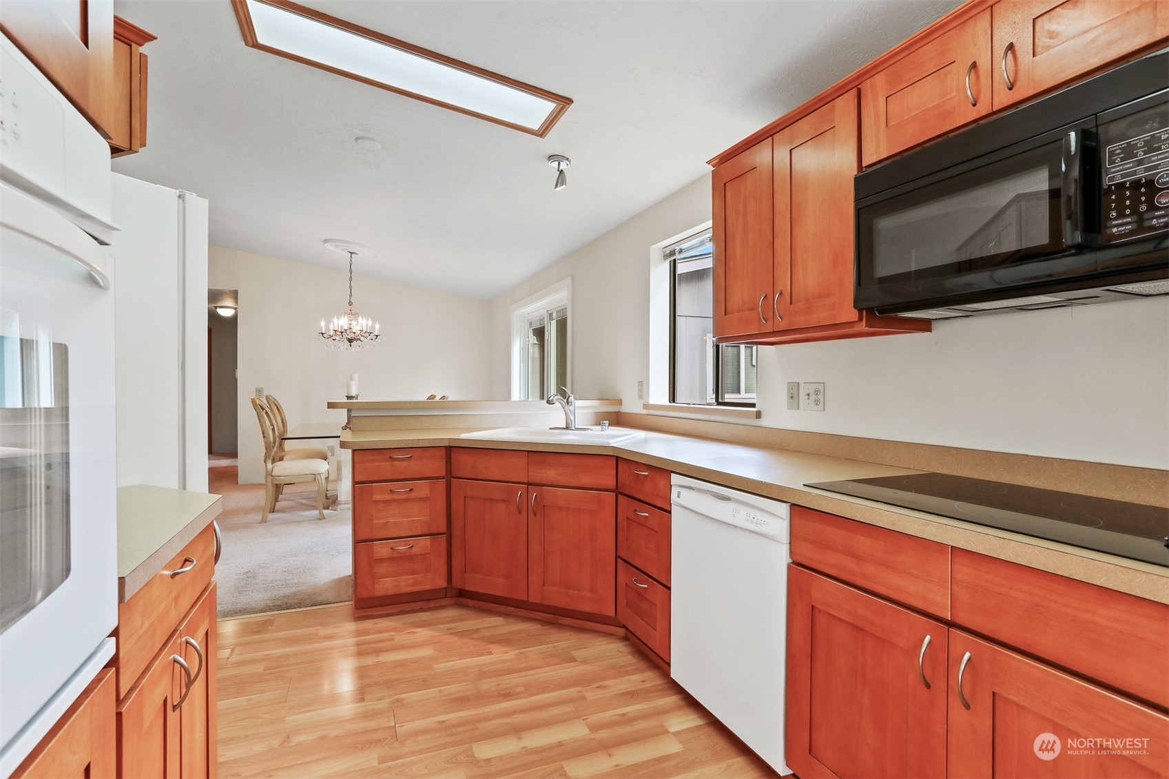 828 240th Place Southwest Bothell, WA 98021 - Photo 9 of 40 a kitchen with stainless steel appliances granite countertop a sink and microwave