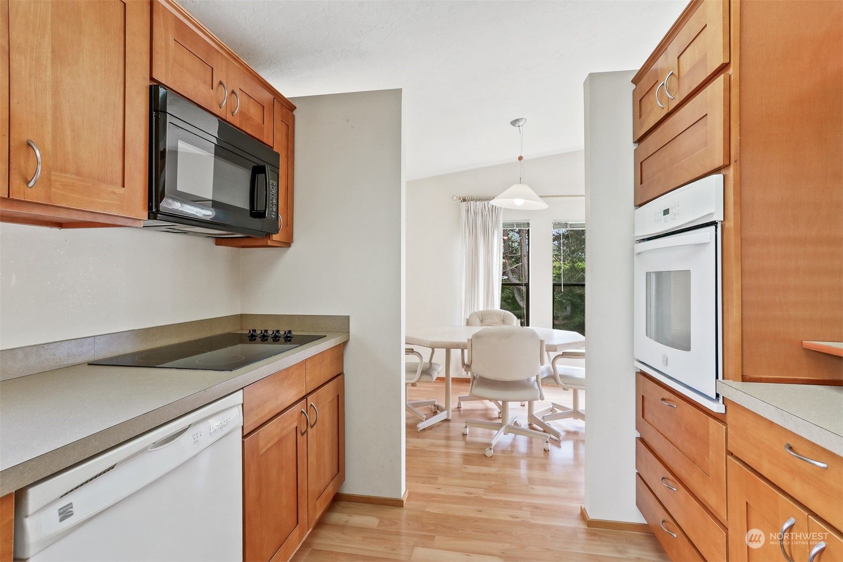 828 240th Place Southwest Bothell, WA 98021 - Photo 10 of 40 a kitchen with stainless steel appliances granite countertop a stove a sink and a microwave