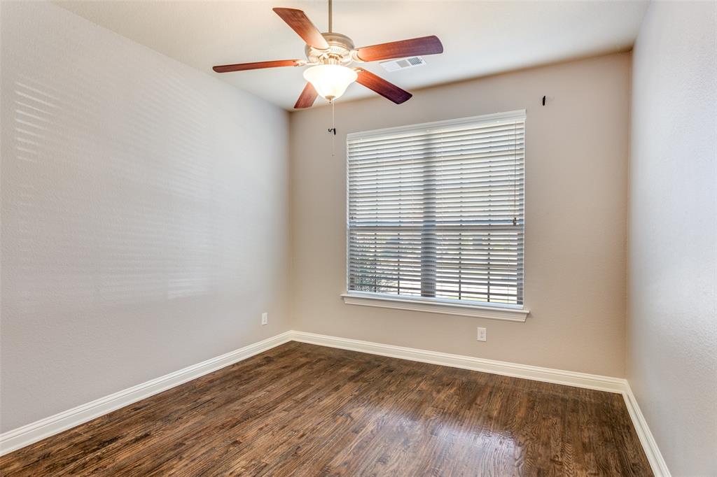 1505 5th Street Argyle, TX 76226 - Photo 5 of 25 a view of an empty room with wooden floor and a window