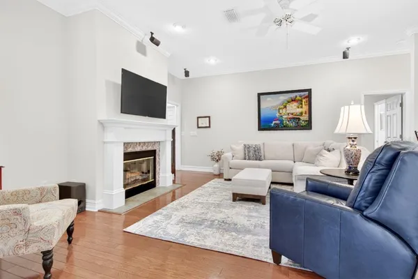 a living room with furniture a flat screen tv and a fireplace