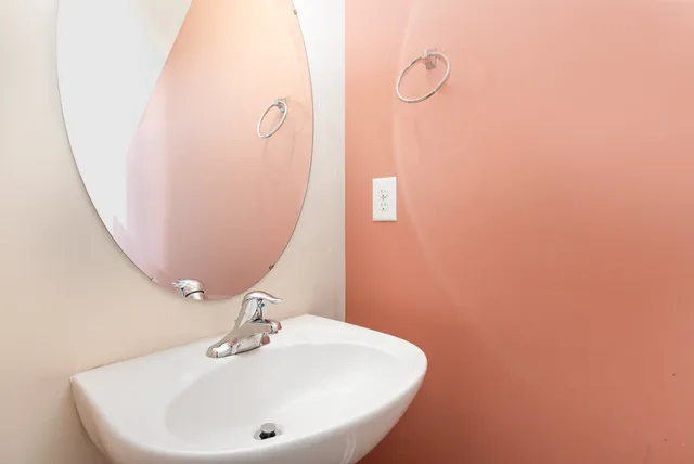 a bathroom with a sink and mirror