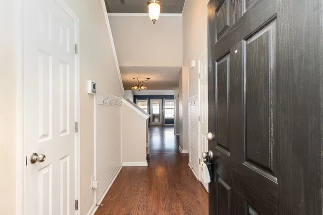 a view of a hallway with wooden floor and staircase