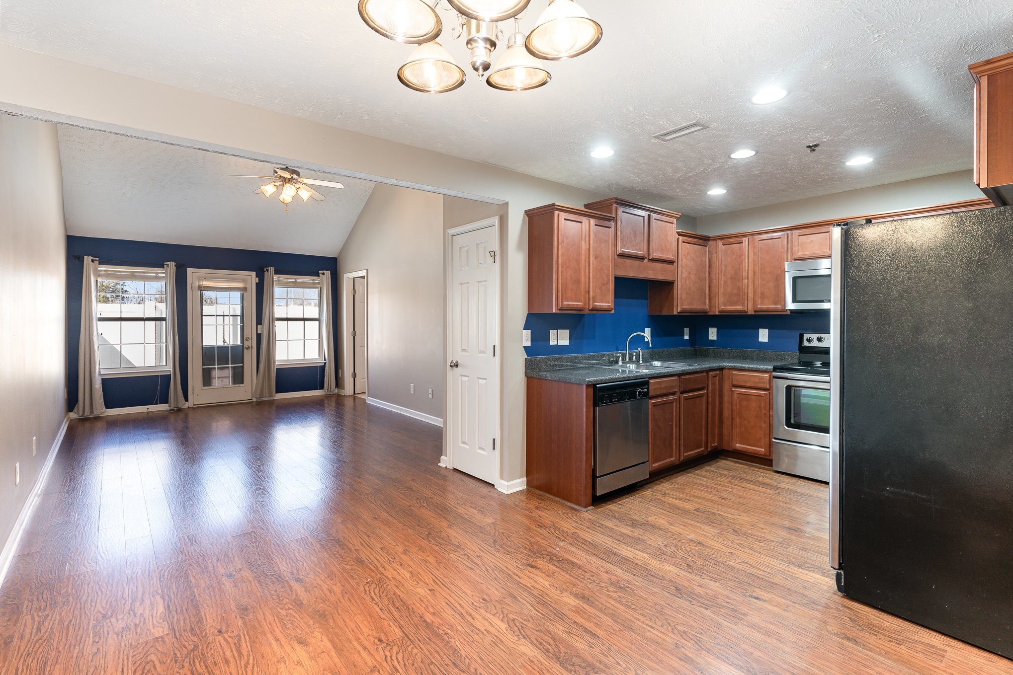 3065 Soaring Eagle Way Spring Hill, TN 37174 - Photo 4 of 25 a kitchen with granite countertop a refrigerator and wooden floors