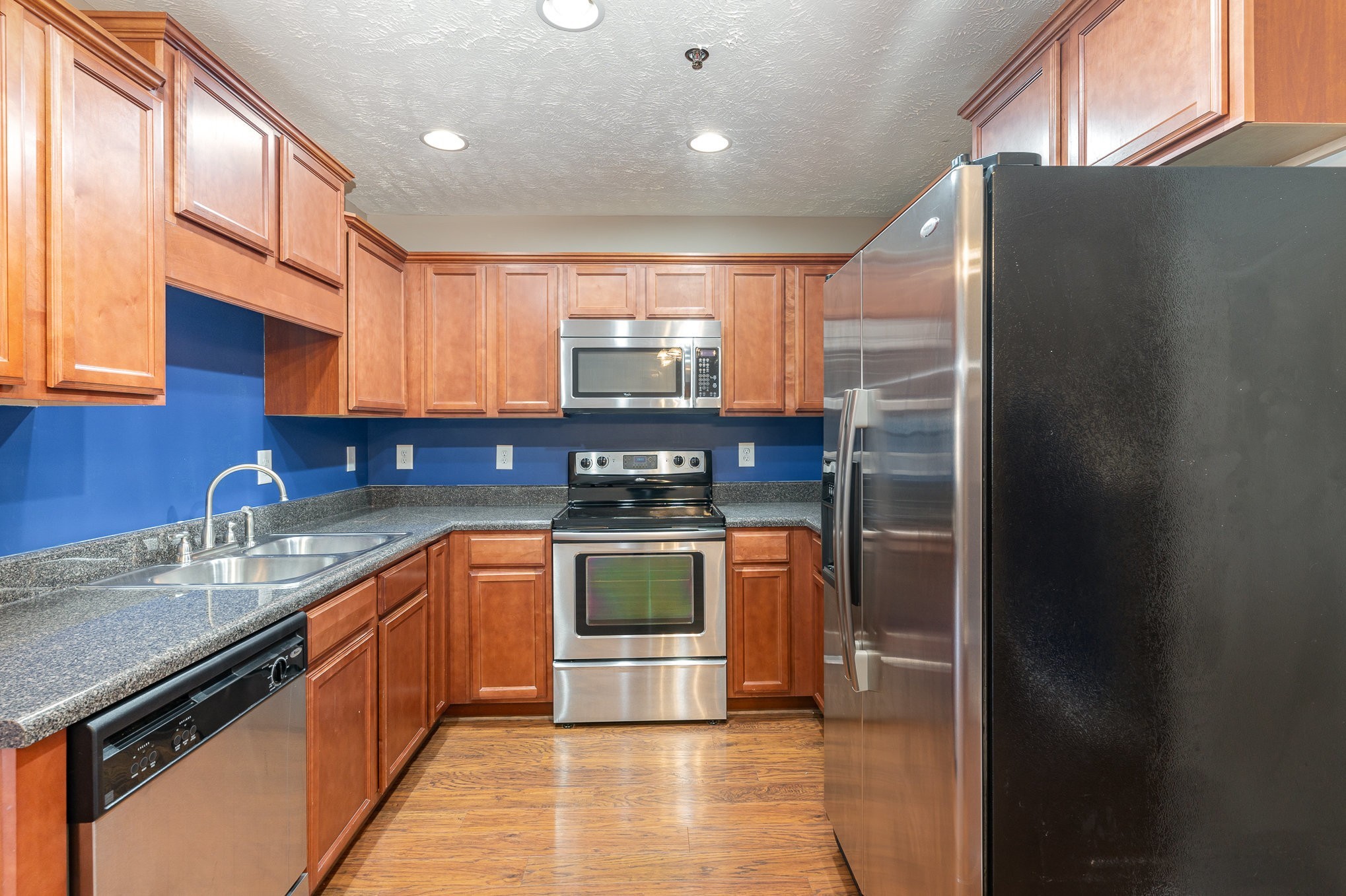 3065 Soaring Eagle Way Spring Hill, TN 37174 - Photo 8 of 25 a kitchen with stainless steel appliances granite countertop a stove a sink and a refrigerator