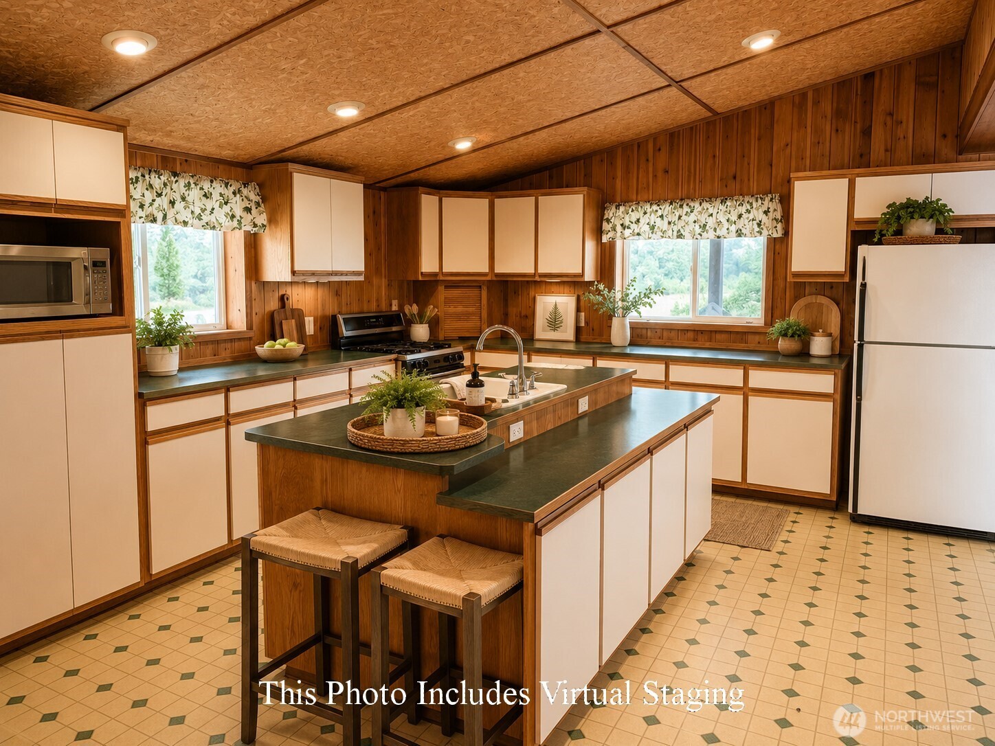 41238 Sterling Valley Road North Lincoln, WA 99147 - Photo 4 of 39 a kitchen with stainless steel appliances granite countertop a sink a stove a refrigerator a microwave oven with a dining table and chairs