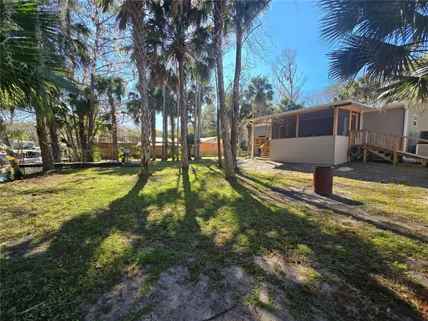 a view of a backyard with swimming pool